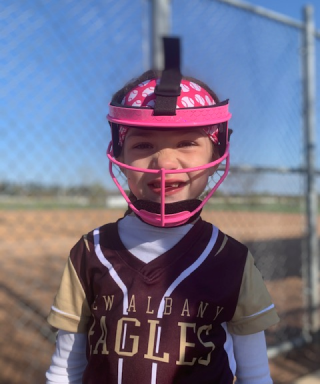 young girl wearing catchers gear