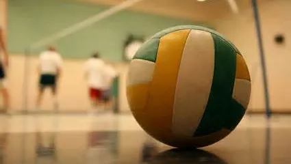 close up of a volleyball with people in the background