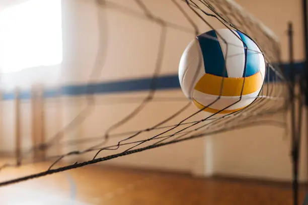 A volleyball hitting the net