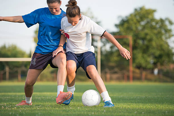 two female soccer players on the field